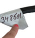 Hand holding a cable with a label showing '348501' on a white background
